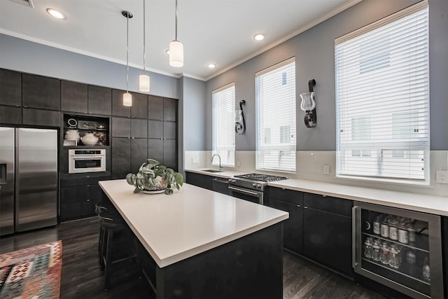 kitchen with a center island, hanging light fixtures, tasteful backsplash, stainless steel appliances, and beverage cooler