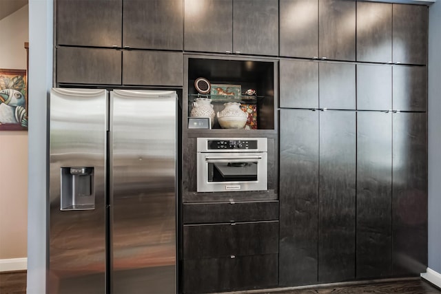 kitchen featuring appliances with stainless steel finishes and dark hardwood / wood-style flooring