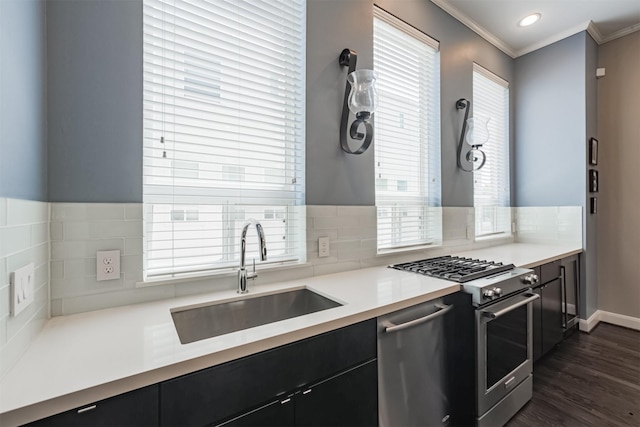 kitchen with sink, tasteful backsplash, dark hardwood / wood-style flooring, crown molding, and appliances with stainless steel finishes