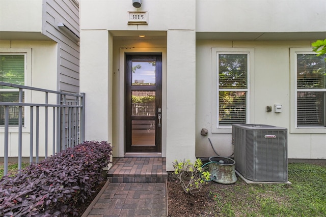 doorway to property featuring cooling unit