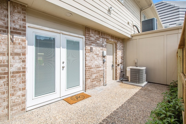 doorway to property featuring cooling unit and french doors