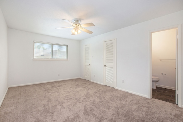 unfurnished bedroom with ceiling fan, connected bathroom, and light carpet