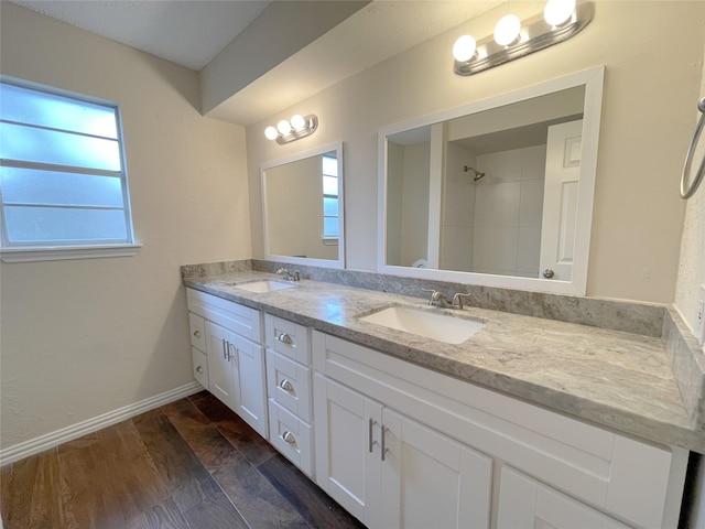 bathroom with a shower, vanity, and hardwood / wood-style flooring