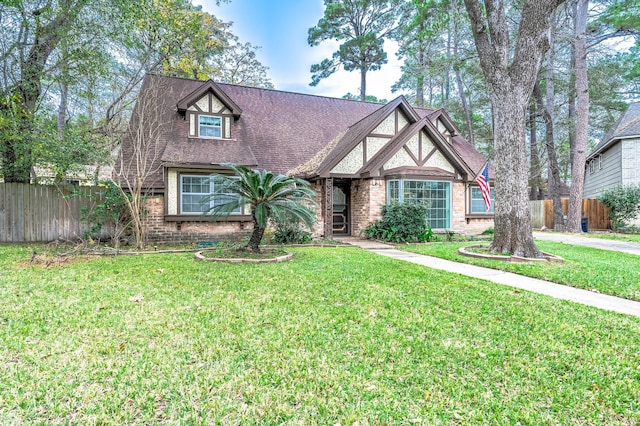 english style home featuring a front yard