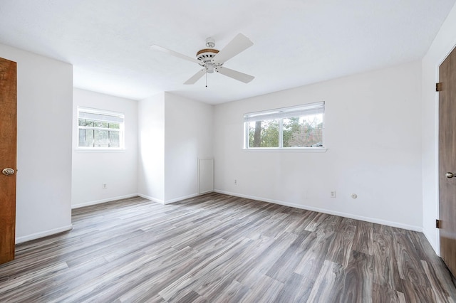 empty room featuring light wood-type flooring and ceiling fan