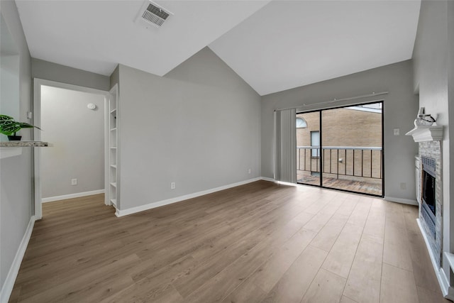 unfurnished living room with light wood-type flooring and lofted ceiling