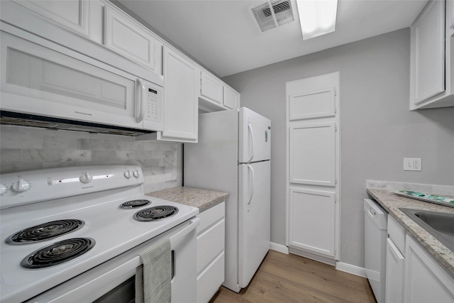 kitchen featuring tasteful backsplash, white cabinetry, light hardwood / wood-style floors, and white appliances