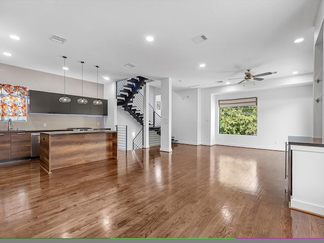 living room featuring ceiling fan, dark hardwood / wood-style flooring, and sink