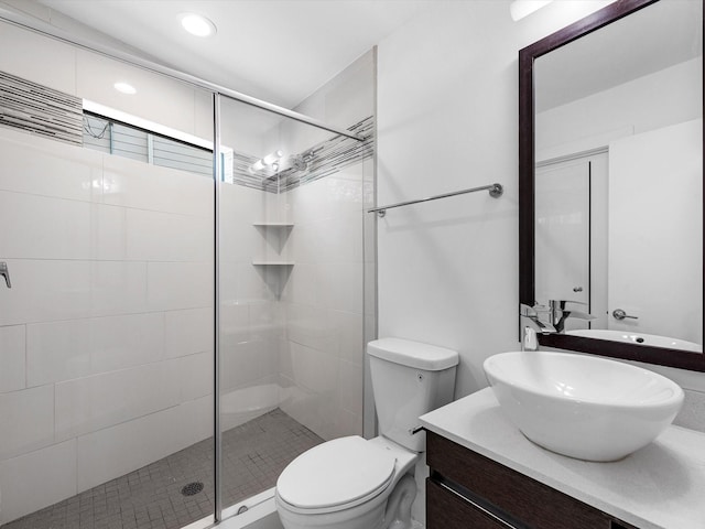 bathroom featuring an enclosed shower, vanity, and toilet