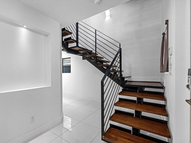 stairway with tile patterned flooring