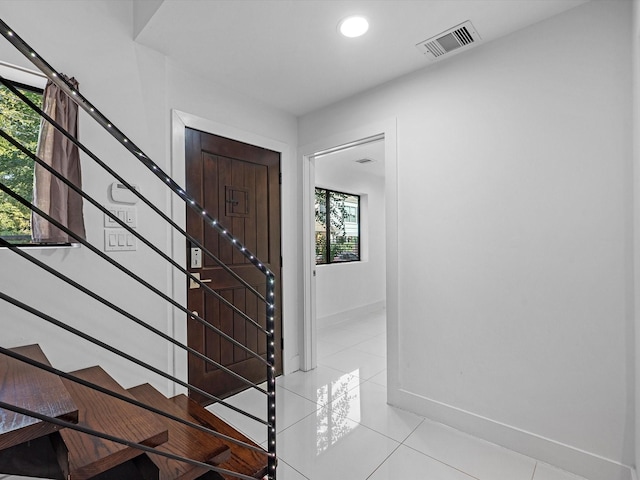 entryway with light tile patterned floors