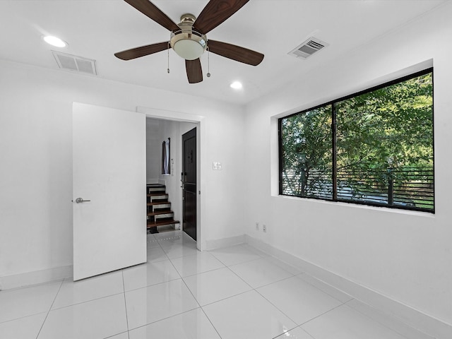 unfurnished bedroom featuring ceiling fan and light tile patterned floors