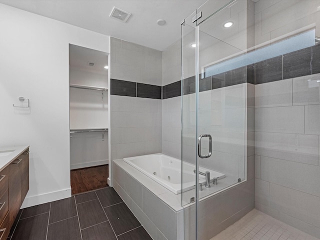 bathroom featuring vanity and separate shower and tub