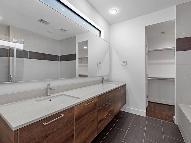 bathroom with a shower and vanity