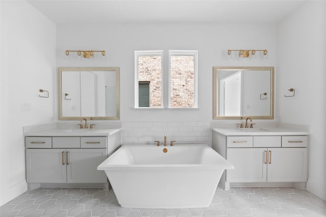 bathroom featuring a tub to relax in, tile patterned flooring, and vanity