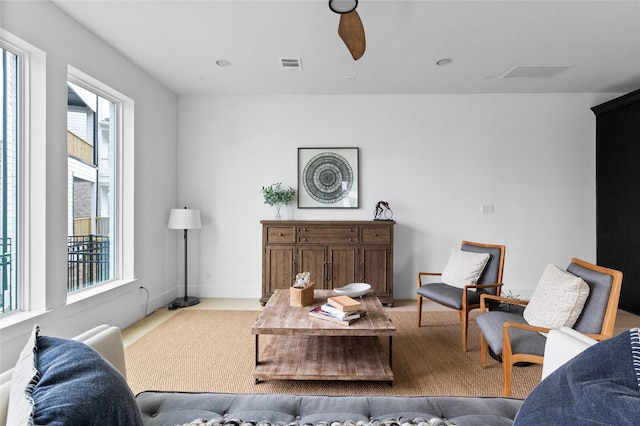 living room featuring a wealth of natural light and ceiling fan