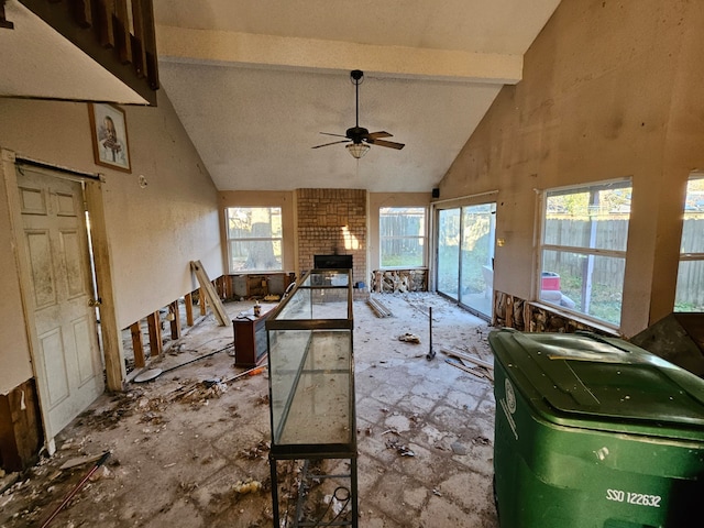 miscellaneous room featuring beamed ceiling, ceiling fan, a fireplace, and high vaulted ceiling