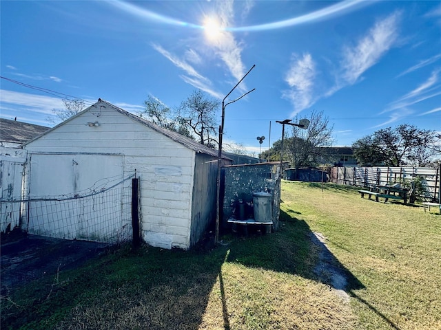 view of outdoor structure featuring a lawn