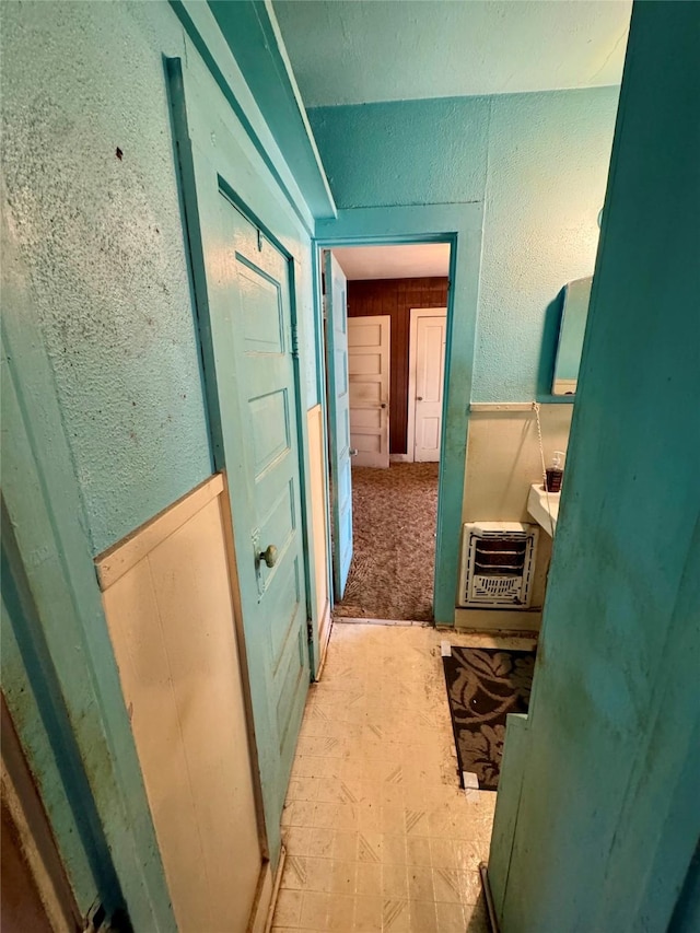 hallway with heating unit and wooden walls