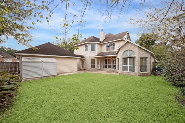 2109 Enchanted Lake Dr, League City, TX 77573 - back of property featuring a patio, a chimney, brick siding, an outbuilding, and roof with shingles