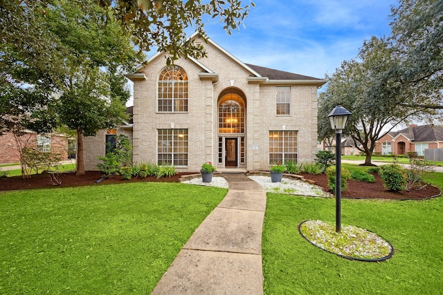 2109 Enchanted Lake Dr, League City, TX 77573 - traditional-style house featuring brick siding and a front yard