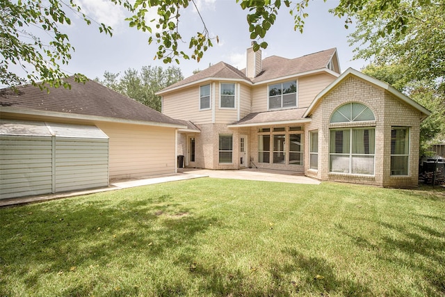 2109 Enchanted Lake Dr, League City, TX 77573 - back of property featuring brick siding, a chimney, a patio, and a yard