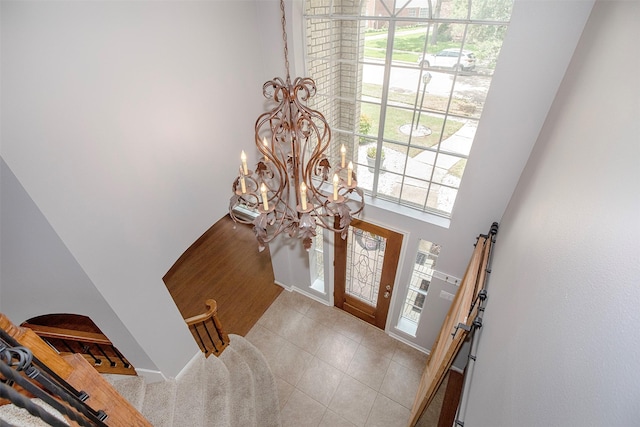 2109 Enchanted Lake Dr, League City, TX 77573 - entryway with a chandelier, tile patterned flooring, and a high ceiling
