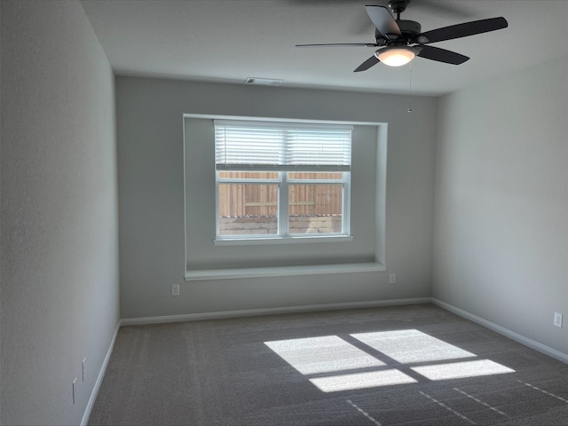 carpeted spare room featuring ceiling fan