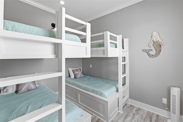 bedroom with crown molding and light hardwood / wood-style floors