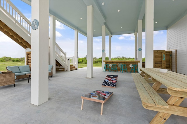 view of patio featuring an outdoor living space and a bar