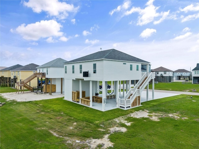 back of house featuring outdoor lounge area, a yard, and a patio