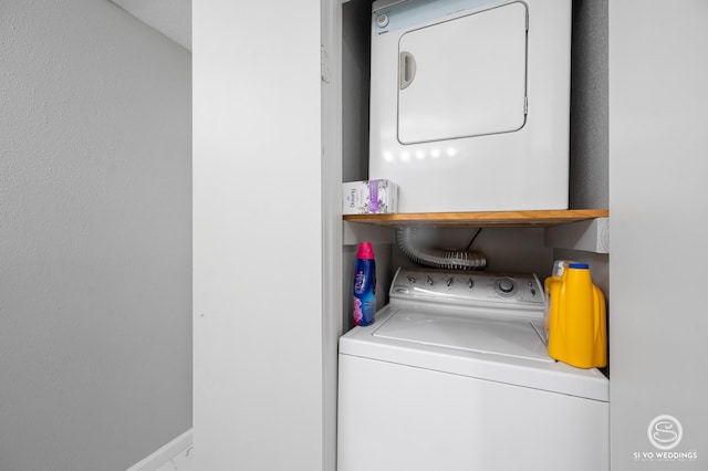 clothes washing area featuring stacked washer / drying machine