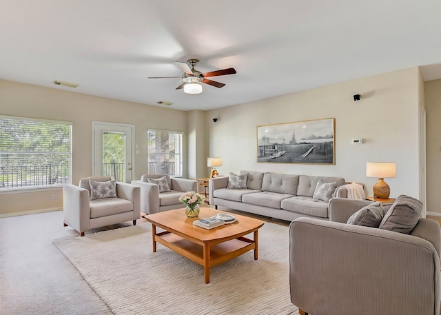 living room with light carpet and ceiling fan