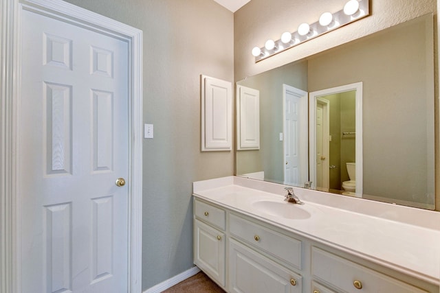 bathroom with toilet and vanity