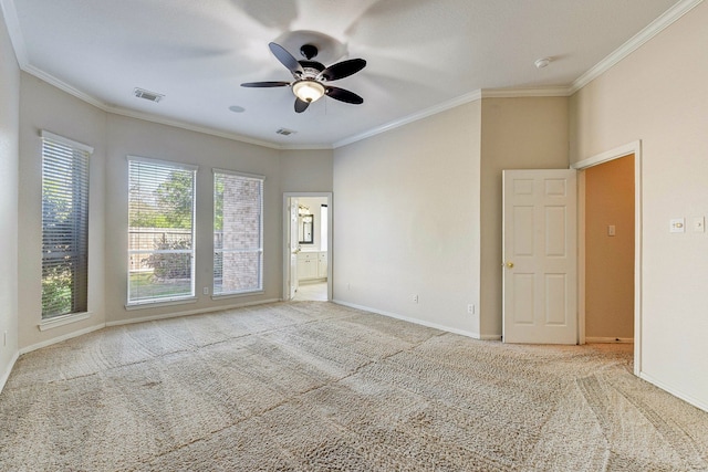 carpeted spare room featuring ceiling fan and ornamental molding