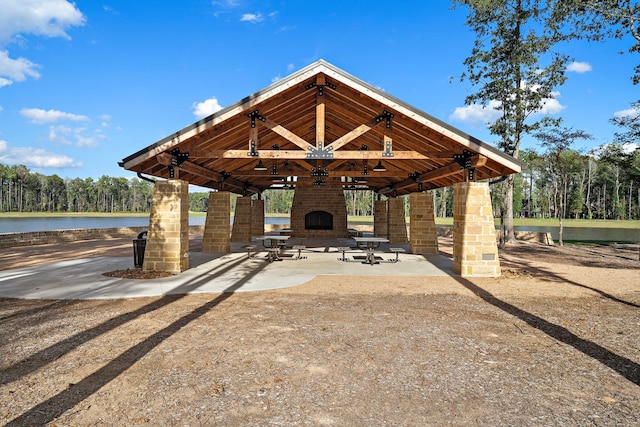 view of community with a water view, a patio, and a gazebo