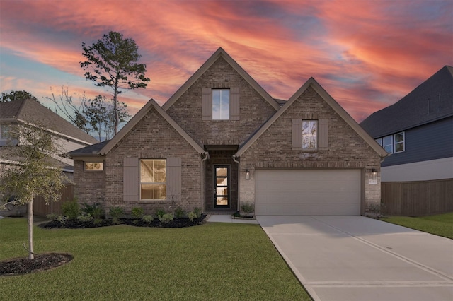 view of front of property with a garage and a yard