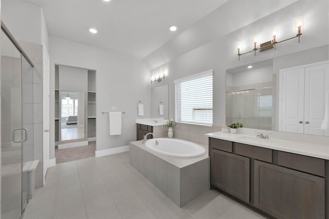 bathroom with tile patterned floors, a healthy amount of sunlight, and plus walk in shower