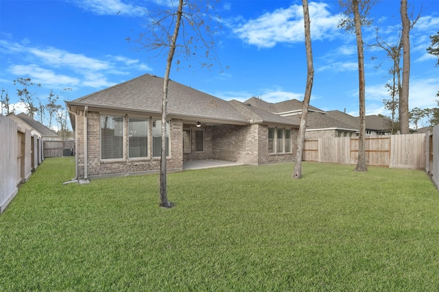 back of house featuring a yard and a patio