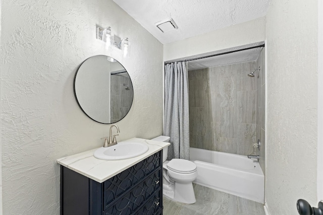 full bathroom with shower / tub combo with curtain, vanity, toilet, and a textured ceiling