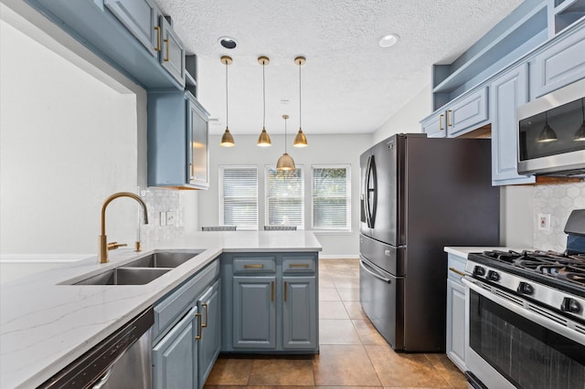 kitchen featuring sink, decorative backsplash, hanging light fixtures, light stone counters, and stainless steel appliances