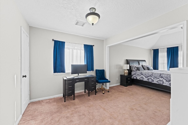 bedroom featuring lofted ceiling, carpet floors, and a textured ceiling