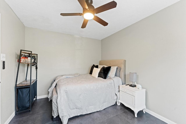 bedroom featuring dark tile patterned floors and ceiling fan