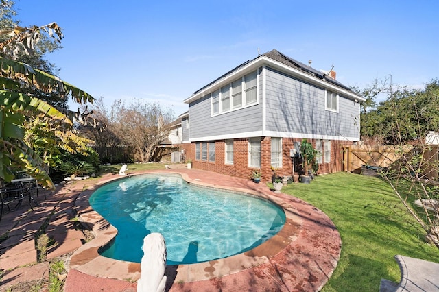 view of swimming pool with a yard and a patio area