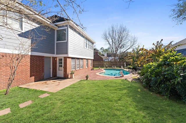 view of yard with a fenced in pool and a patio