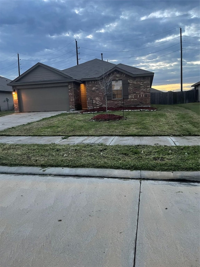 view of front of home featuring a front yard and a garage