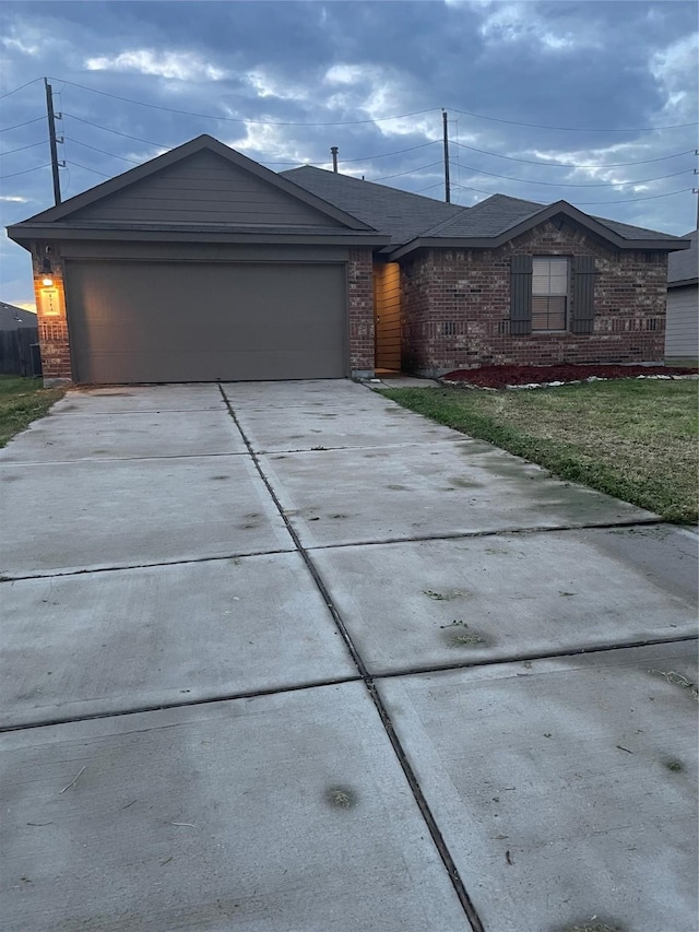 ranch-style home with a front lawn and a garage