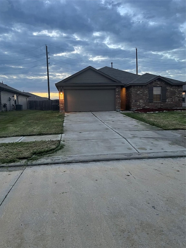 view of front of home with a garage and a front lawn