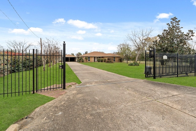 view of gate with a lawn