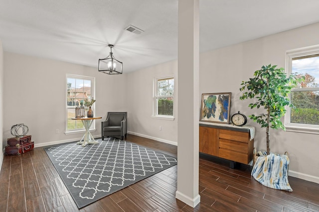 sitting room featuring dark hardwood / wood-style flooring and an inviting chandelier